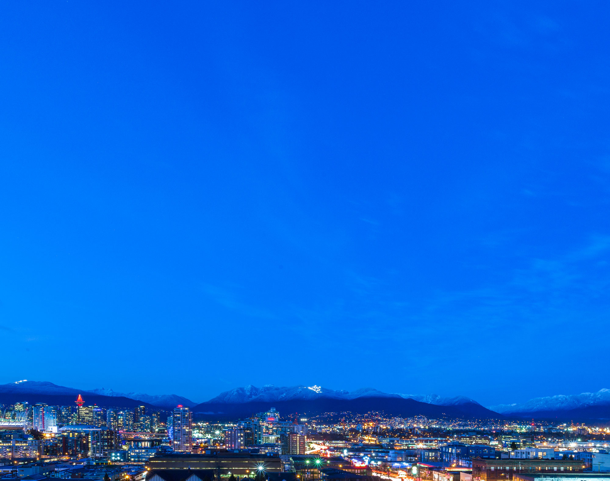 Blue hour skyline with mountains in the background